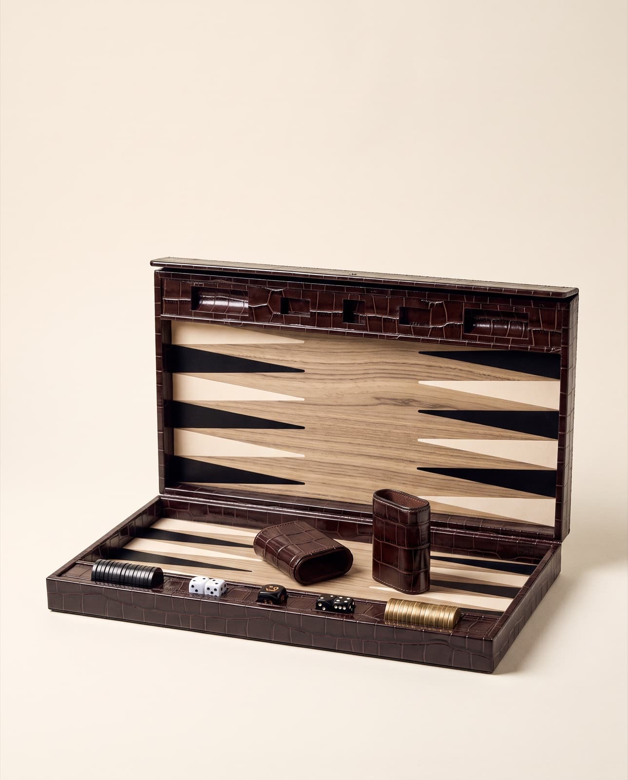 The Heirloom Board in Havana, open — crocodile-embossed leather case, pale oak field, ebony and brass checkers